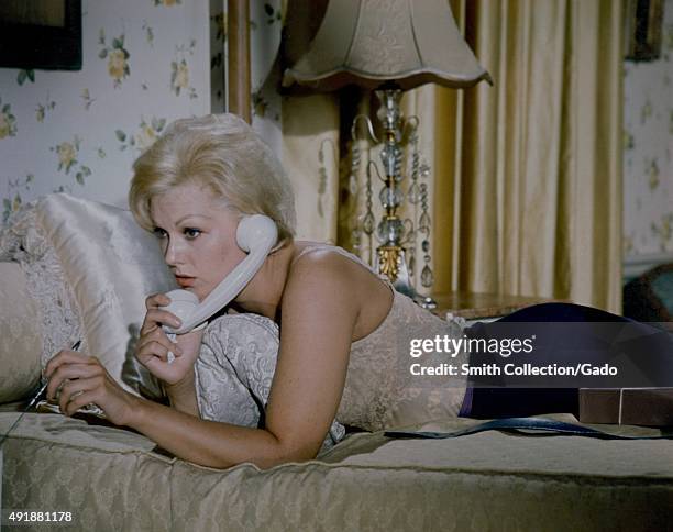 Kim Novak speaking on the phone, in a color movie still, 1960.