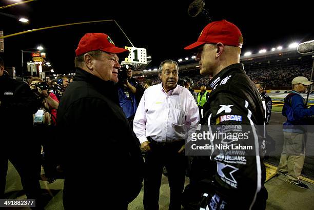 Chip Ganassi , owner of Chip Ganassi racing, and Felix Sabates, a team owner, talk to a crew member during the NASCAR Sprint Cup Series Sprint...