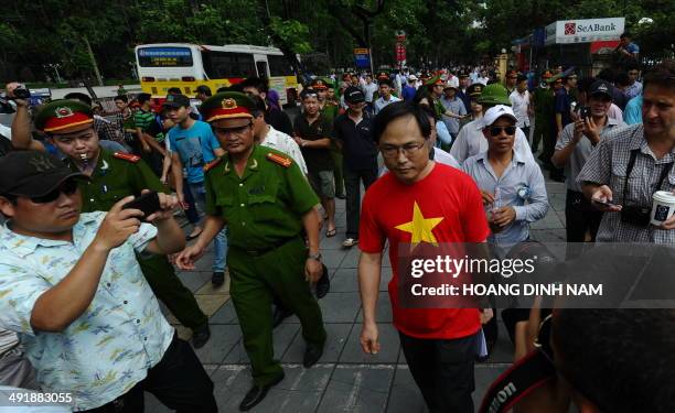 Policemen ask people to leave a street near to the Chinese embassy in Hanoi on May 18, 2014. A call for further anti-China protests appeared to have...