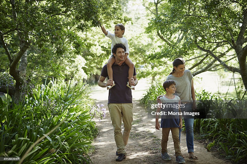 Two generation family walking in park