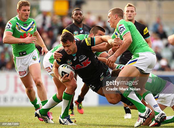 Joel Edwards of the Panthers is tackled during the round 10 NRL match between the Canberra Raiders and the Penrith Panthers at GIO Stadium on May 18,...