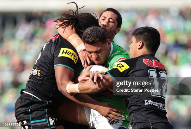 Josh Papalii of the Raiders is tackled during the round 10 NRL match between the Canberra Raiders and the Penrith Panthers at GIO Stadium on May 18,...