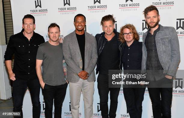 Golfer Tiger Woods and members of the band OneRepublic guitarist Zach Filkins, drummer Eddie Fisher, singer Ryan Tedder, guitarist Drew Brown and...