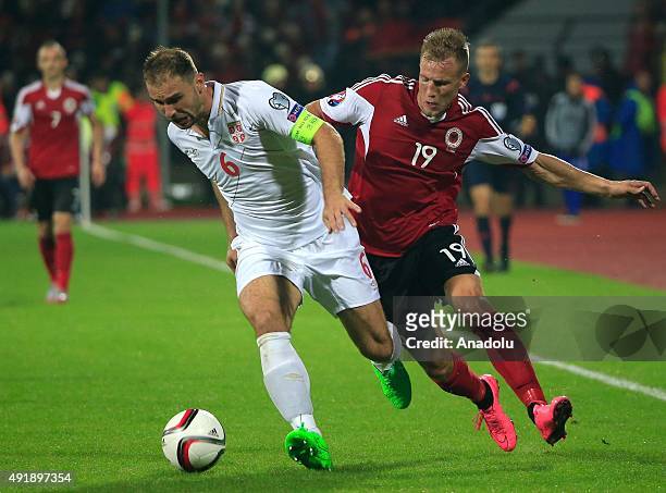 Branislav Ivanovic of Serbia vies with Bekim Balaj of Albania during the UEFA EURO 2016 qualifying group I soccer match between Albania and Serbia in...