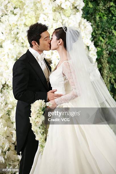 Huang Xiaoming and Anglababy during their wedding ceremony at Shanghai Exhibition Center on October 8, 2015 in Shanghai, China.