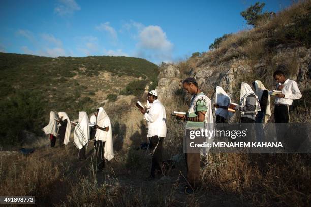 Ultra-Orthodox Jews pray during a ceremony at the grave site of Rabbi Shimon Bar Yochai in the northern Israeli village of Meron on May 18 at the...