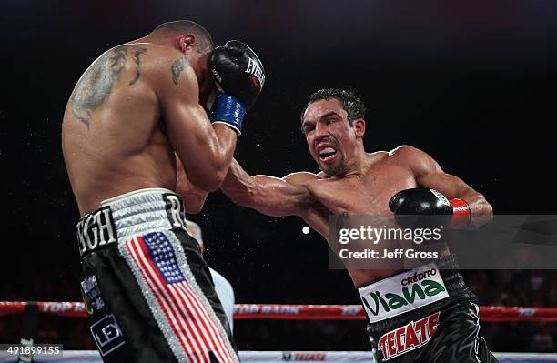 Juan Manuel Marquez throws a right hand at Mike Alvarado at The Forum on May 17, 2014 in Inglewood, California.