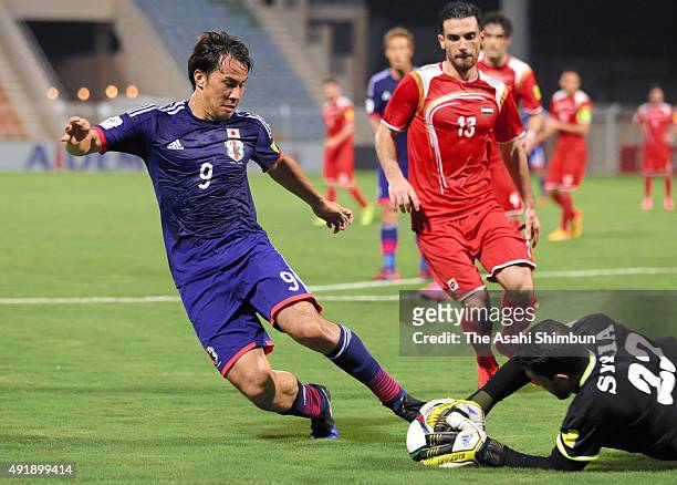 Shinji Okazaki of Japan and Ibrahim Almeh of Syria compete for the ball during the 2018 FIFA World Cup Asian Group E qualifying match between Syria...
