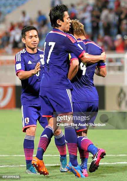 Keisuke Honda of Japan of Japan celebrates scoring his team's first goal with his teammates Makoto Hasebe and Yuto Nagatomo during the 2018 FIFA...