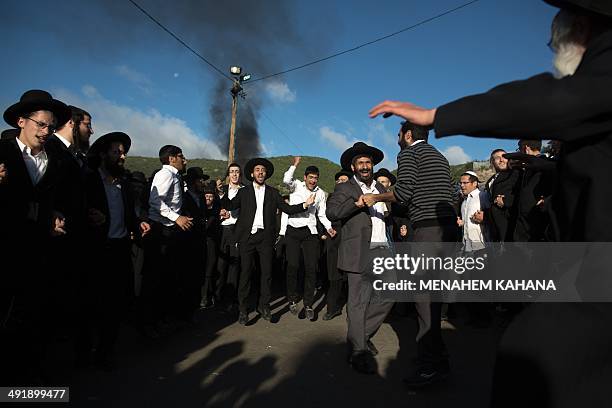 Ultra-Orthodox Jews dance at the grave site of Rabbi Shimon Bar Yochai in the northern Israeli village of Meron on May 18 at the start of the...