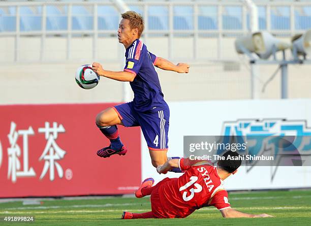 Keisuke Honda of Japan and Nadim Sabagh of Syria compete for the ball during the 2018 FIFA World Cup Asian Group E qualifying match between Syria and...