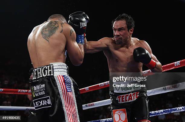 Juan Manuel Marquez throws a right hand at Mike Alvarado at The Forum on May 17, 2014 in Inglewood, California.