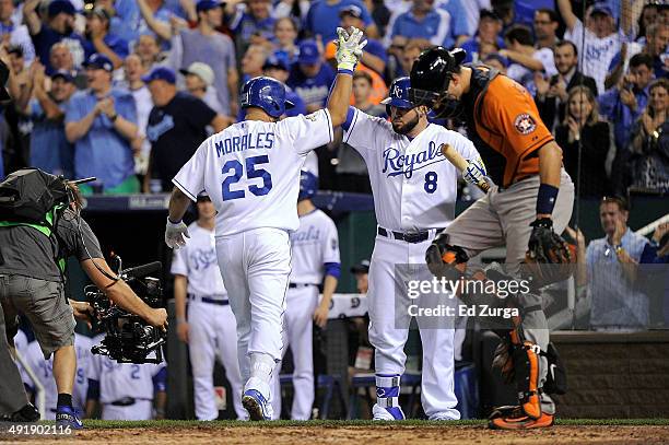 Kendrys Morales of the Kansas City Royals is congratulated by Mike Moustakas of the Kansas City Royals after hitting a solo home run in the fourth...