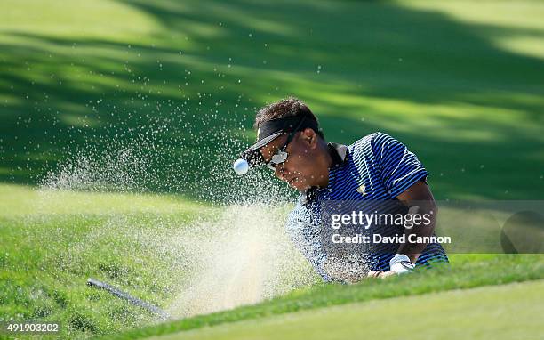 Thongchai Jaidee of Thailand and the International Team plays his fourth shot on the third hole in his match with Charl Schwartzel against Bill Haas...