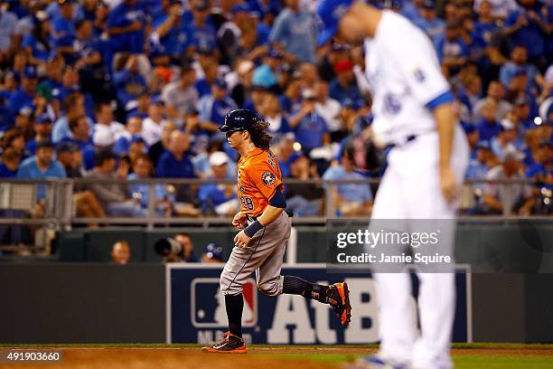 Colby Rasmus of the Houston Astros runs the bases after hitting a solo home run as Ryan Madson of the Kansas City Royals reacts in the eighth inning...