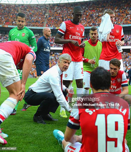 Arsene Wenger, manager of Arsenal speaks with his players at the end of full-time before entering extra-time during the FA Cup with Budweiser Final...