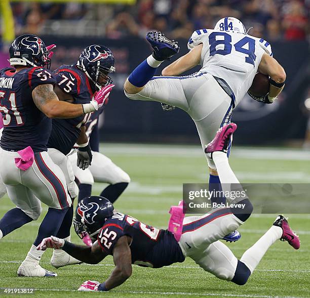 Jack Doyle of the Indianapolis Colts is tripped up by Kareem Jackson of the Houston Texans n the fourth quarter on October 8, 2015 at NRG Stadium in...