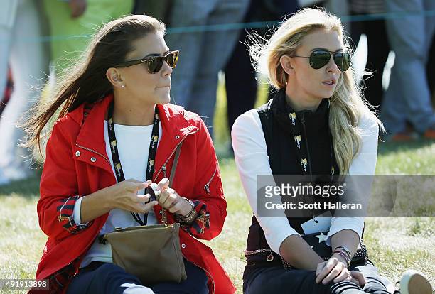 Annie Verret and Paulina Gretzky watch the play of the United States Team on the ninth hole during the Friday four-ball matches at The Presidents Cup...