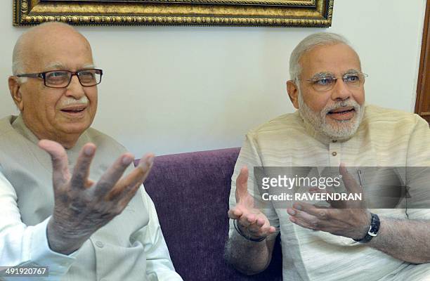 Indian prime-minister elect Narendra Modi and Bharatiya Janata Party senior leader Lal Krishna Advani gesture to the press at Gujarat bhawan in New...