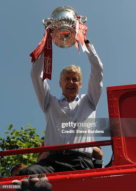 Arsene Wenger, manager of Arsenal FC celebrates with the FA Cup on board the Arsenal team bus during the Arsenal FA Cup Victory Parade in Islington,...