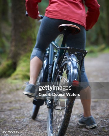 Woman on bicycle in woodland. Woman on bicycle in woodland.