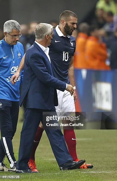 Karim Benzema of France is replaced by head coach of France Didier Deschamps after getting injured during the international friendly match between...