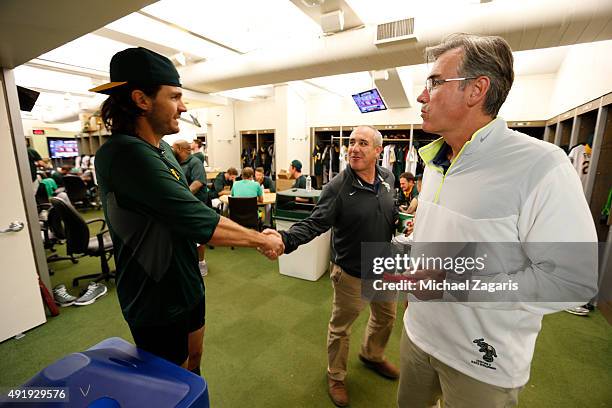 Barry Zito, Owner Lew Wolff and General Manager Billy Beane of the Oakland Athletics talk in the clubhouse prior to the game against the Texas...