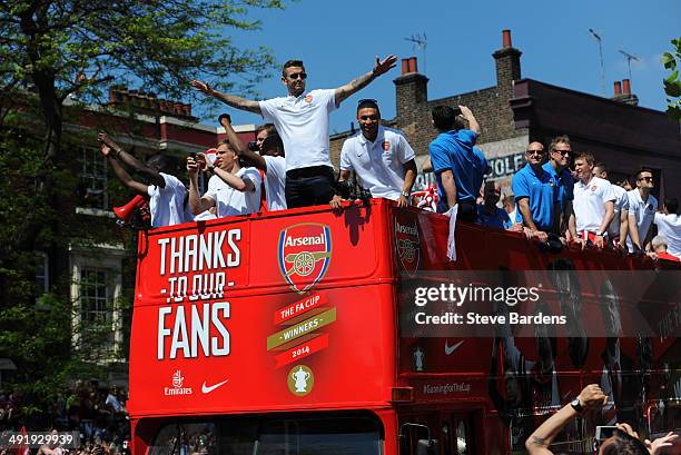 Jack Wilshere of Arsenal FC and his team mates celebrate on their bus during the Arsenal FA Cup Victory Parade in Islington, London on May 18, 2014...