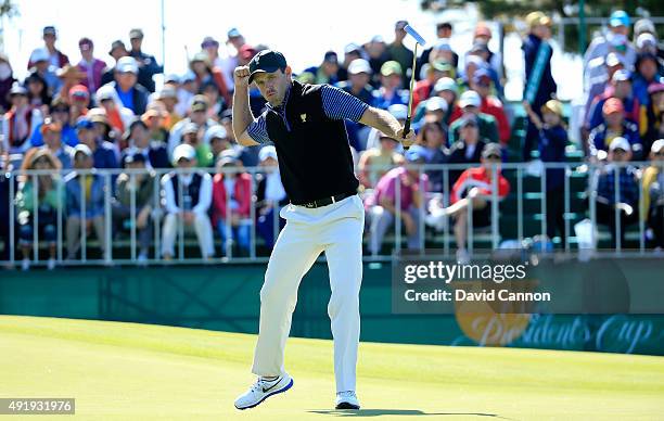 Charl Schwartzel of South Africa and the International Team celebrates as he holes a birdie putt to win the hole on the 13th green in his match with...
