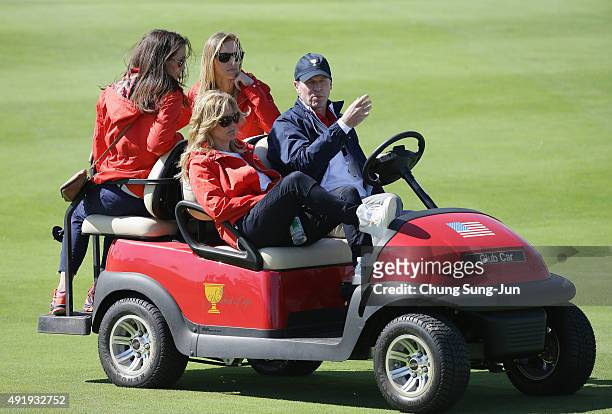 Sybi Kucha, Erin Walker, Tabitha Furyk and caotain's assistant Steve Stricker of the United States Team ride a golf cart during the Friday four-ball...