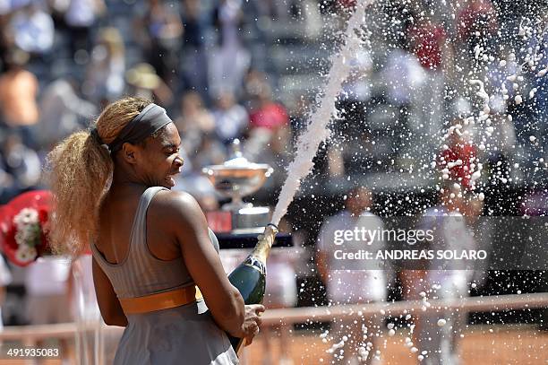 Serena Williams sprays champagne as she celebrates after beating Italian Sara Errani in the WTA Rome's Tennis Masters final on May 18 at the Foro...