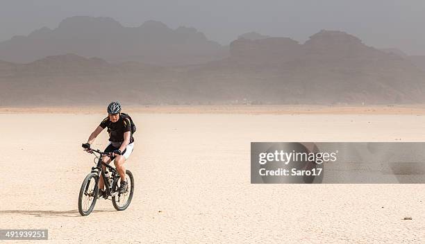 moutainbiking on a desert lake, jordan - gravel cycling stock pictures, royalty-free photos & images