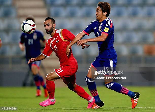 Hiroshi Kiyotake of Japan battles for the ball with Osama Omari of Syriaduring the 2018 FIFA World Cup Asian Group E qualifying match between Syria...