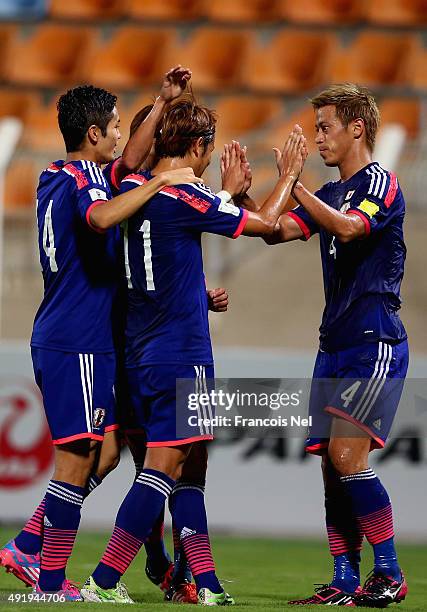 Keisuke Honda of Japan celebrates with teammates after scoring his team's second goal during the 2018 FIFA World Cup Asian Group E qualifying match...