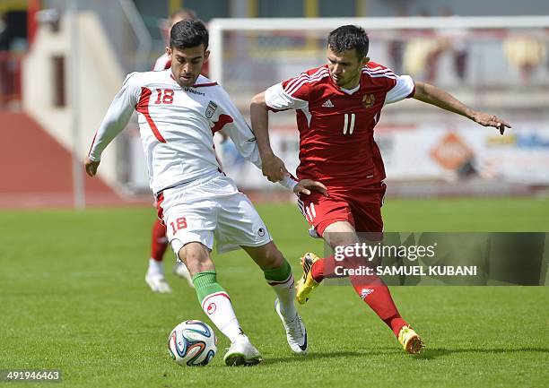 Iran's midfielder Bakhtiar Rahmani and Belarus' midfielder Alyaksandr Valadzko vie for the ball during the friendly football match Iran vs Belarus in...