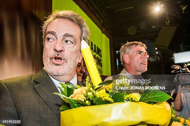 Flemish far-right Vlaams Belang chairman Gerolf Annemans and Vlaams Belang Flemish Parliament member Filip Dewinter holds bouquets and large pencils...