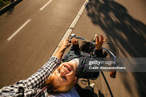 father and son cycling together - point of view stock pictures, royalty-free photos & images