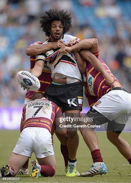 Luke George of Bradford Bulls is tackled by Luke Robinson and Leroy Cudjoe of Huddersfield Giants during the Super League match between Huddersfield...