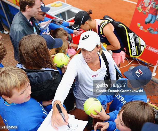Liezel Huber and Lisa Raymond of the United States sign autographs after their match against Nicole Melichar and Natalie Pluskota of the United...