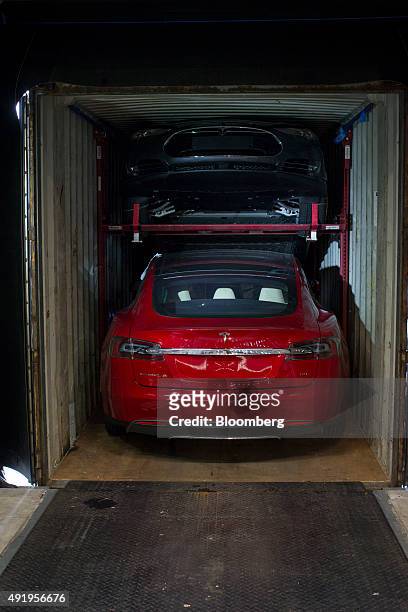 Tesla Model S automobiles sit in a shipping container as they arrive for final assembly at the Tesla Motors Inc. Factory in Tilburg, Netherlands, on...