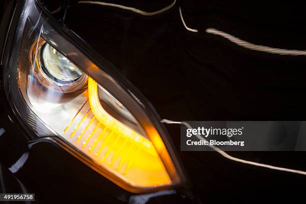 Headlight sits illuminated on a new Tesla Model S automobile ahead of European shipping following final assembly at the Tesla Motors Inc. Factory in...