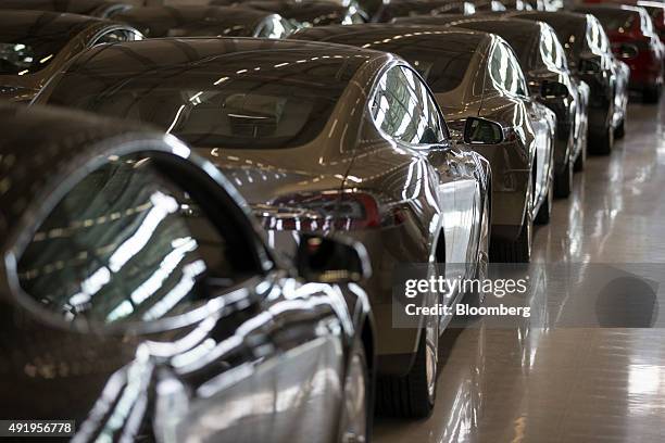 New Tesla Model S automobiles stand in a delivery area ahead of European shipping following final assembly at the Tesla Motors Inc. Factory in...