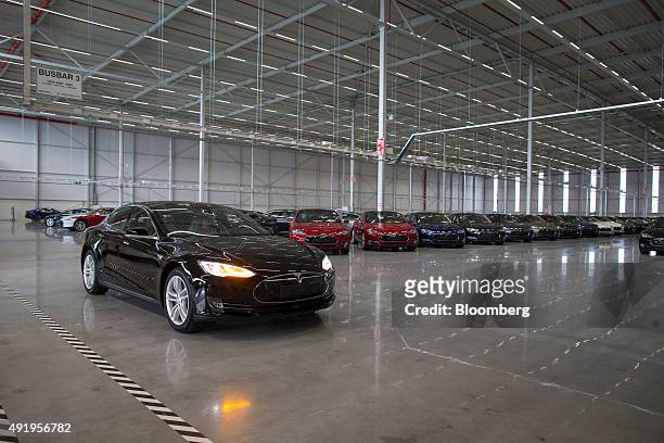 New Tesla Model S automobile is driven into a delivery area ahead of European shipping following final assembly at the Tesla Motors Inc. Factory in...