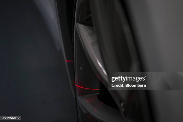 Laser aligns a wheels on a Tesla Model S automobile during final assembly at the Tesla Motors Inc. Factory in Tilburg, Netherlands, on Thursday, Oct....