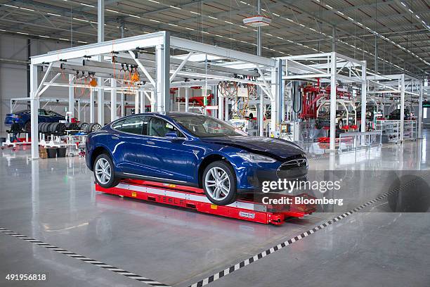 New Tesla Model S automobile stands on a platform ahead of final testing at the Tesla Motors Inc. Factory in Tilburg, Netherlands, on Thursday, Oct....