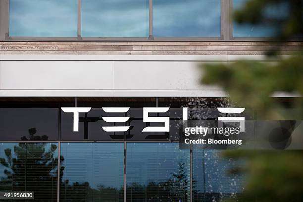 The Tesla logo sits on the exterior of the Tesla Motors Inc. Factory in Tilburg, Netherlands, on Thursday, Oct. 8, 2015. Tesla said it delivered...