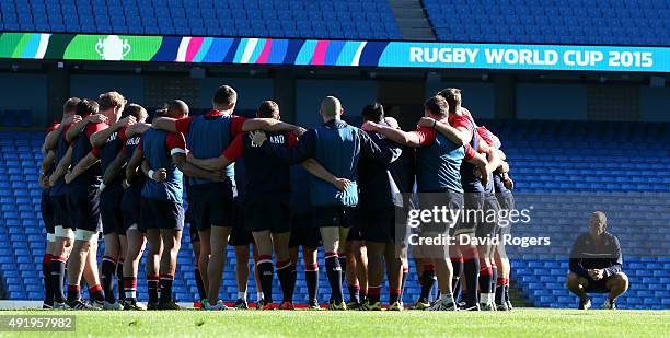 Stuart Lancaster, the England head coach looks on as his team gather during the England captain's run at the City of Manchester Stadium on October 9,...