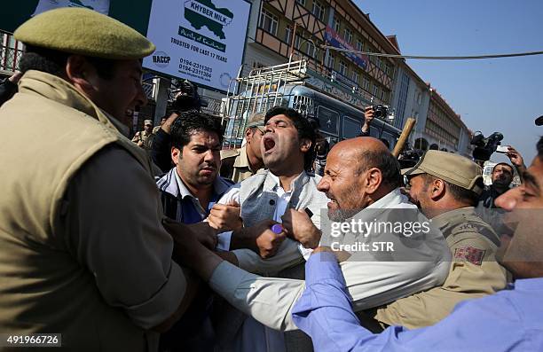 Independent lawmaker Engineer Sheikh Rashid scuffles with Indian police near the Legeslative Assembly during a protest against legislators from the...