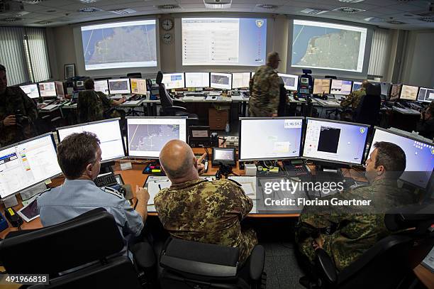 Three european soldiers work in the NATO Combined Air Operations Centre on October 06, 2015 in Uedem, Germany. Here the german airspace get...