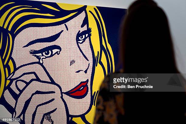 Guest views 'Crying Girl' by artist Roy Lichtenstein during the preview ahead of the artist's muse: a curated evening sale at Christie's New York on...